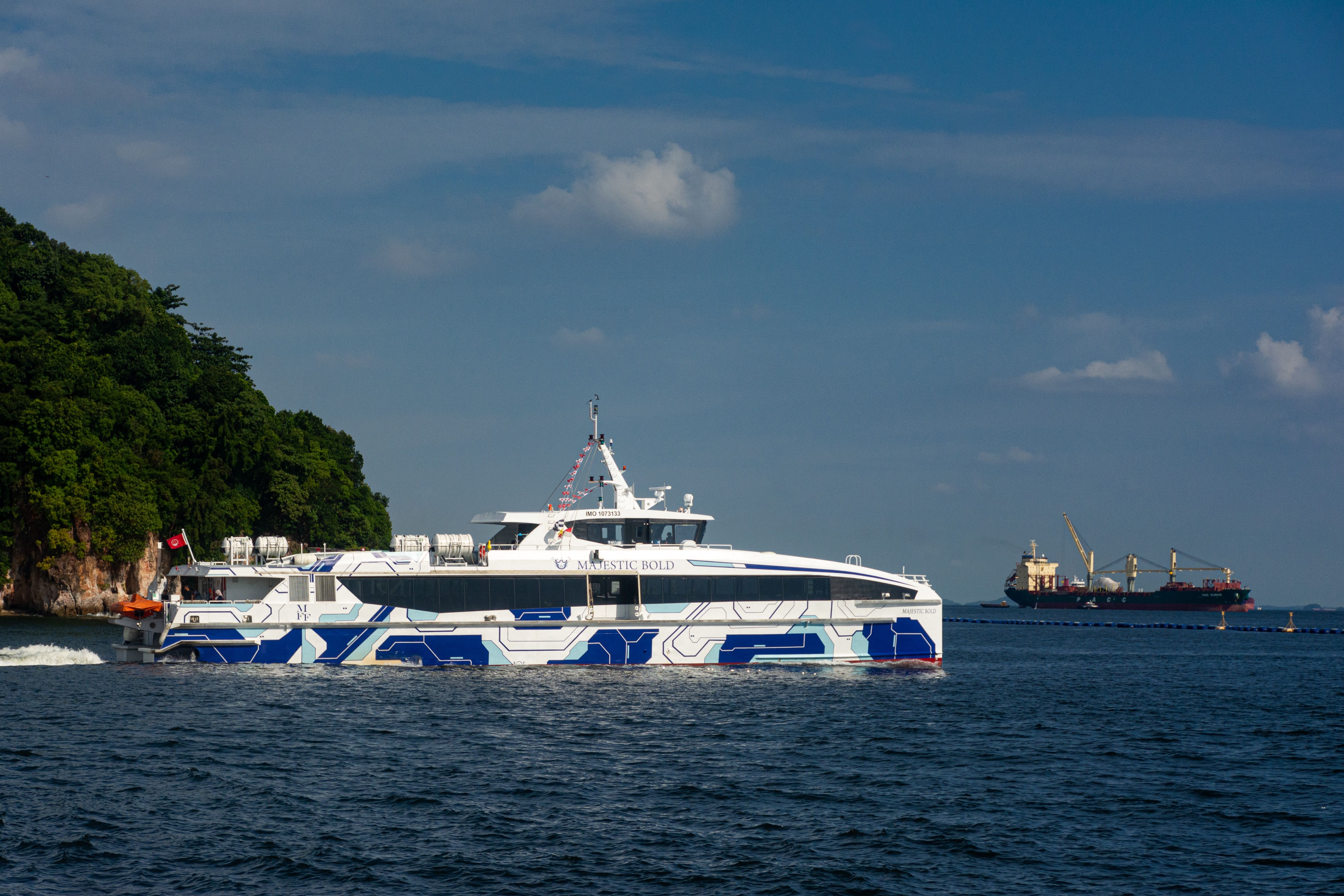 Modern Ferry Boat Cruising Near Lush Island Coastline · Free Stock Photo