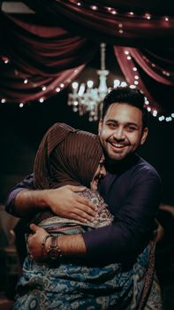 A heartwarming embrace between a mother and son during a joyous family gathering in Karachi, Pakistan.
