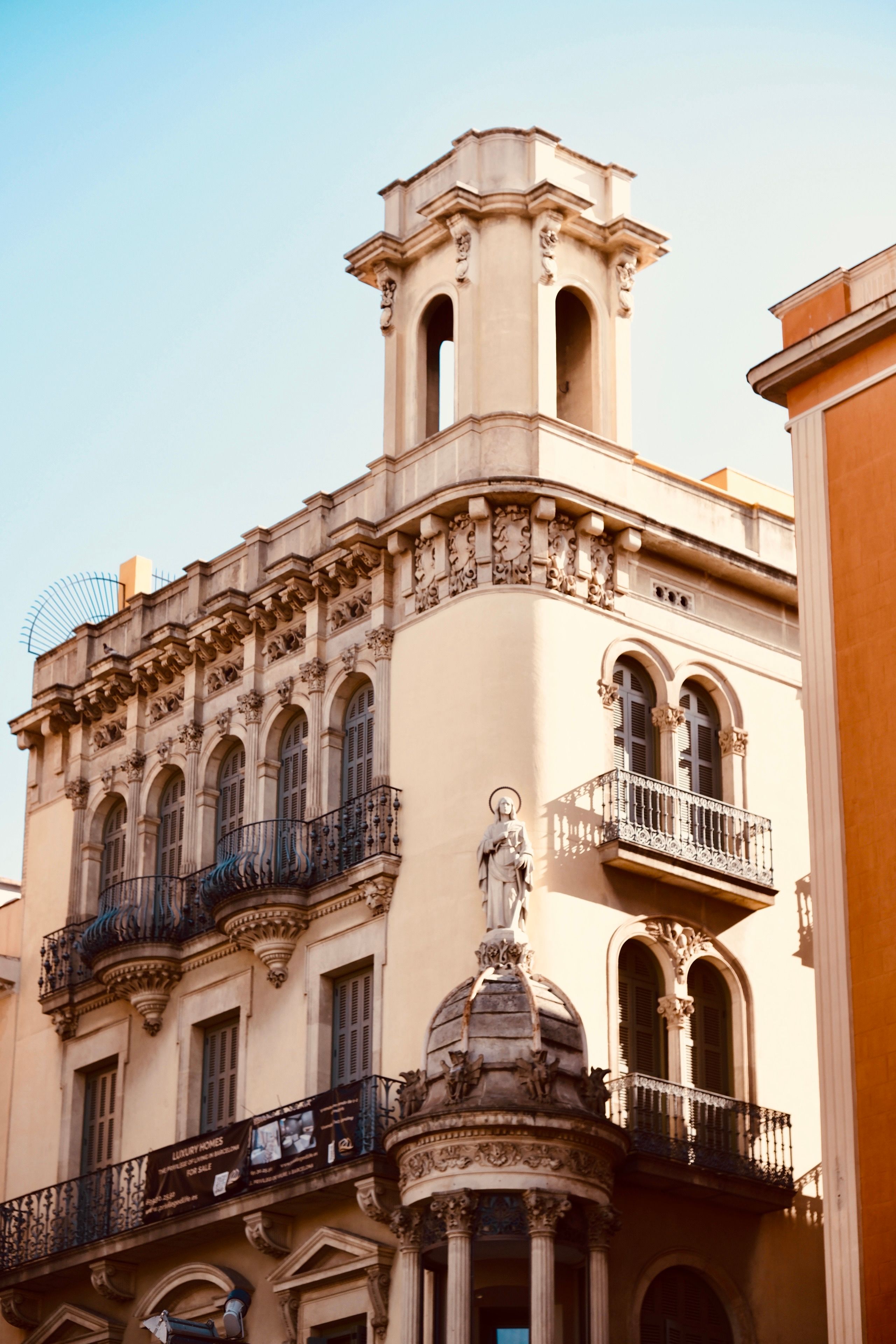 Historic European Architecture with Statue and Balcony · Free Stock Photo
