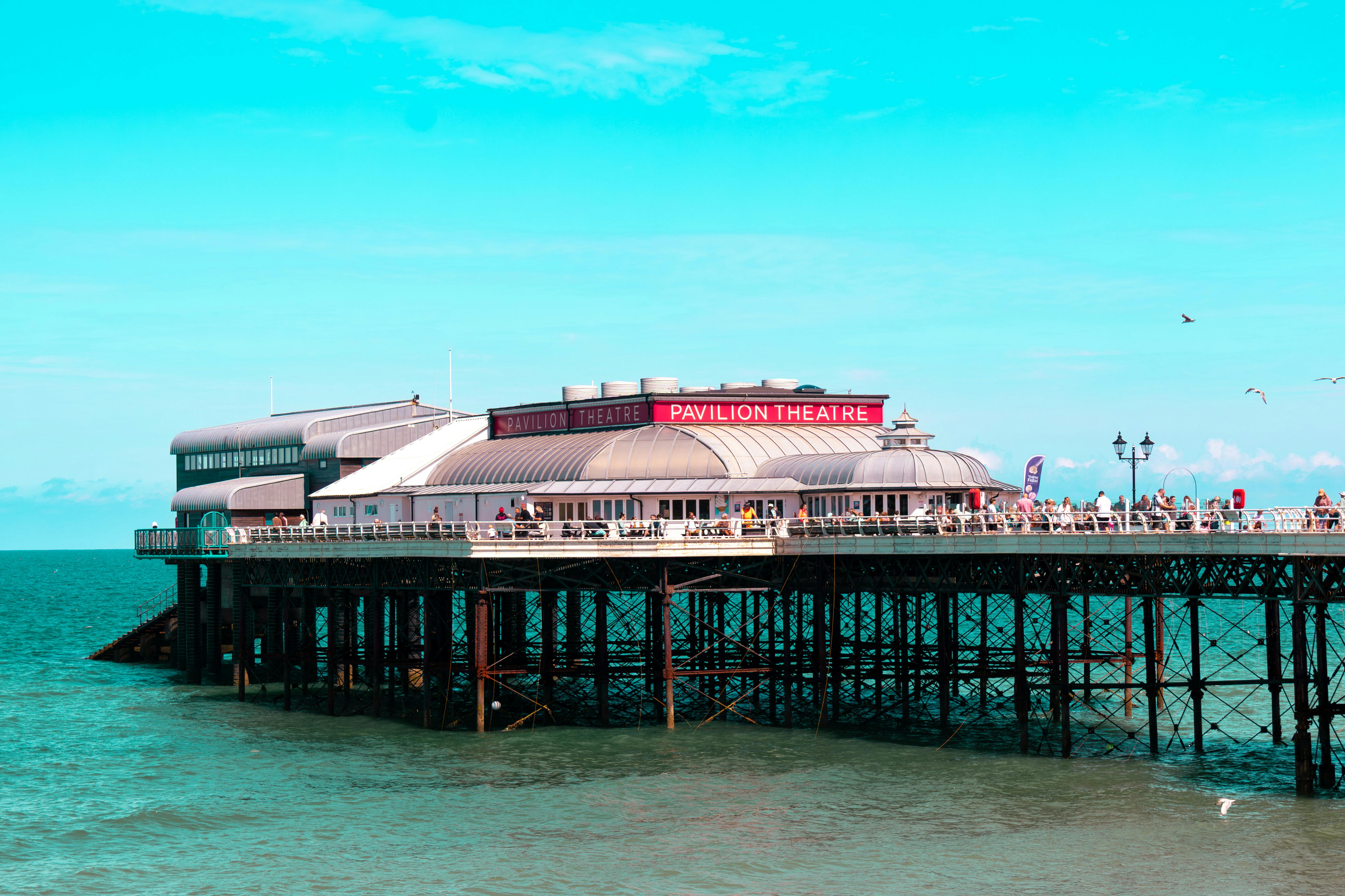 Vibrant view of Cromer Pier's Pavilion Theatre against a clear blue sky in summer, Norfolk, UK.