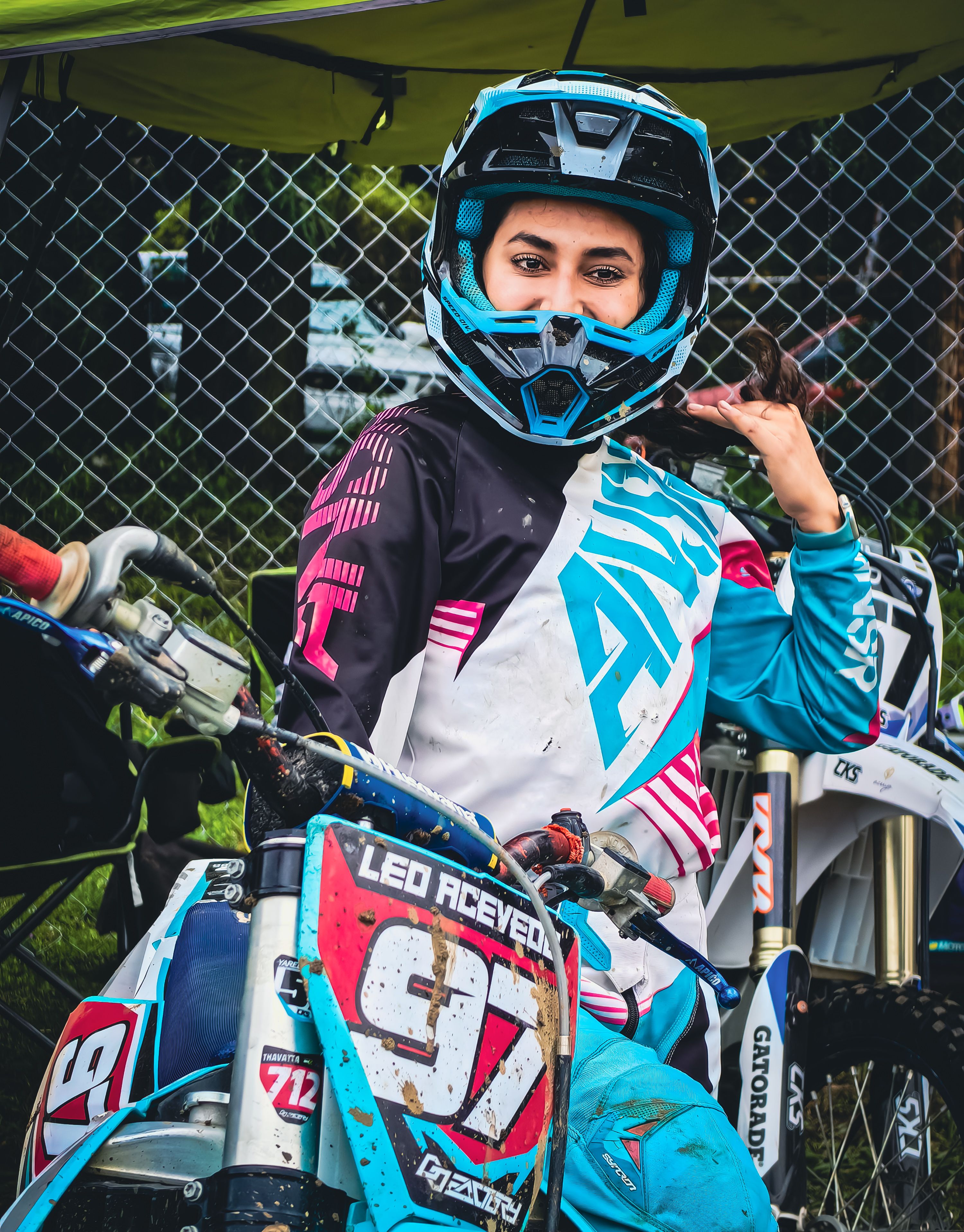 Female motocross racer in full gear resting · Free Stock Photo