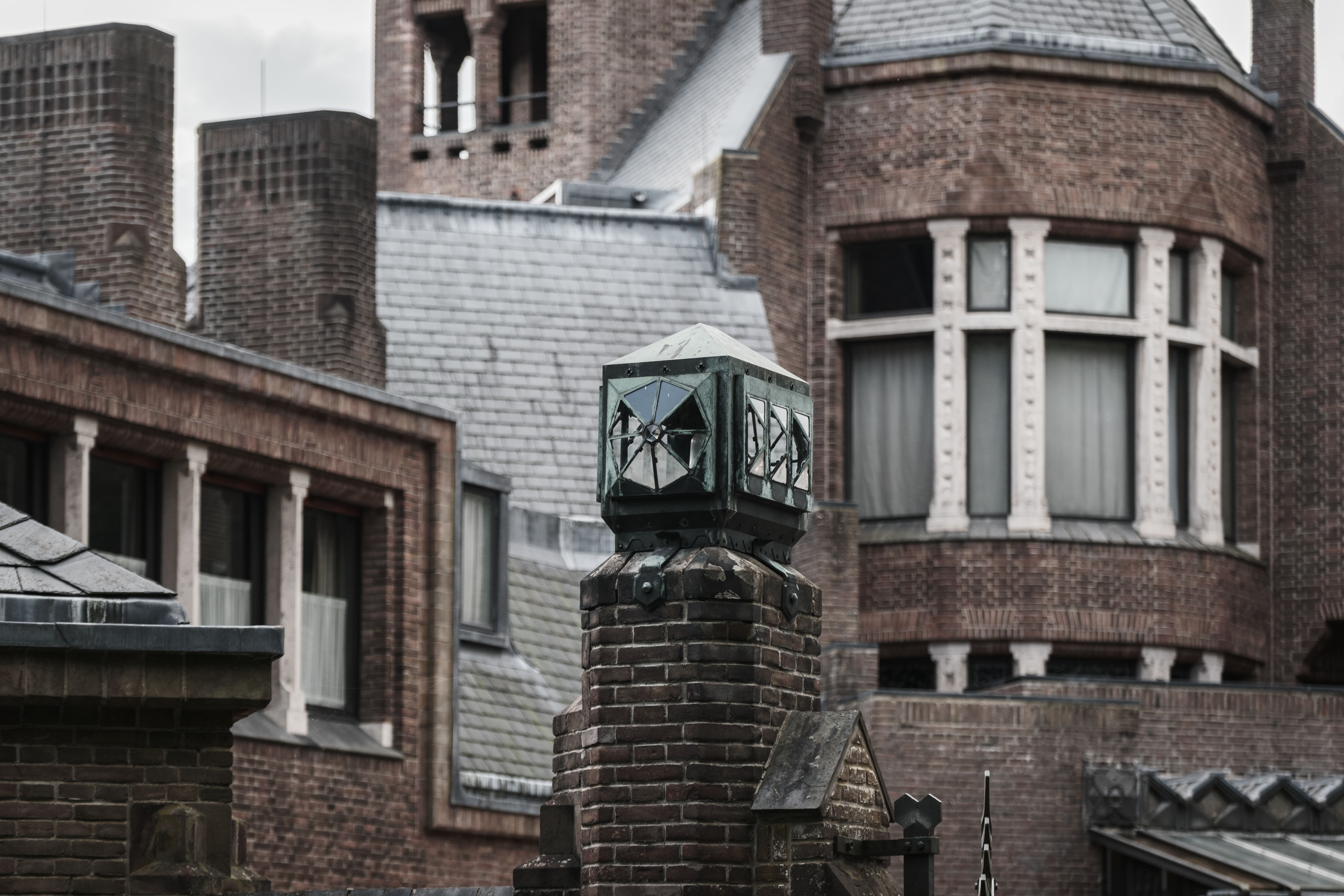 Detailed view of brick gothic architecture with decorative elements and windows.