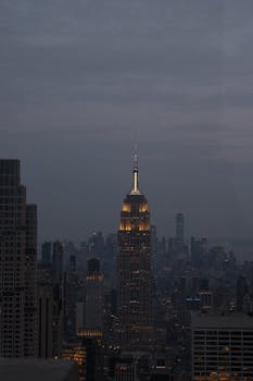 Stunning nighttime view of the Empire State Building illuminated against New York City's skyline.