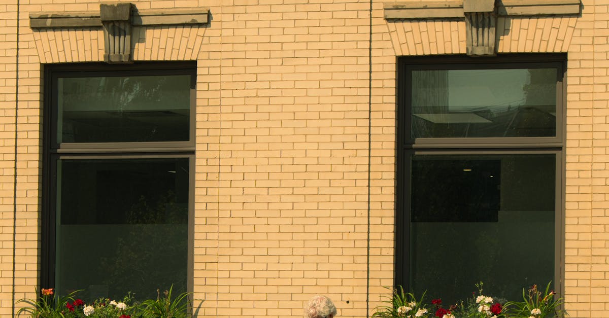 Cyclist Resting by a Brick Building in City · Free Stock Photo Cyclist Resting by a Brick Building in City · Free Stock Photo