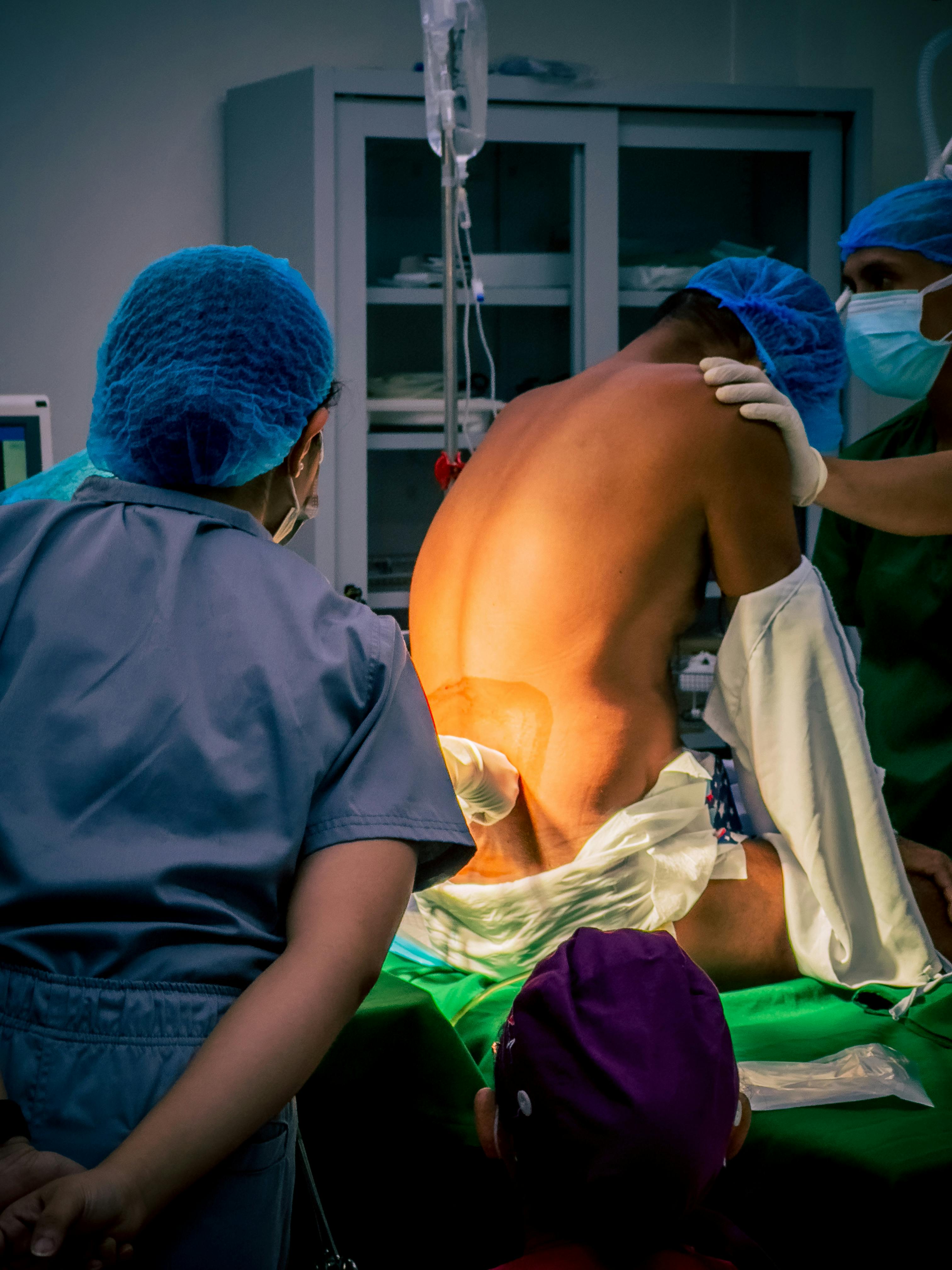 Healthcare professionals prepare patient in a Central Visayas hospital operating room for surgery.