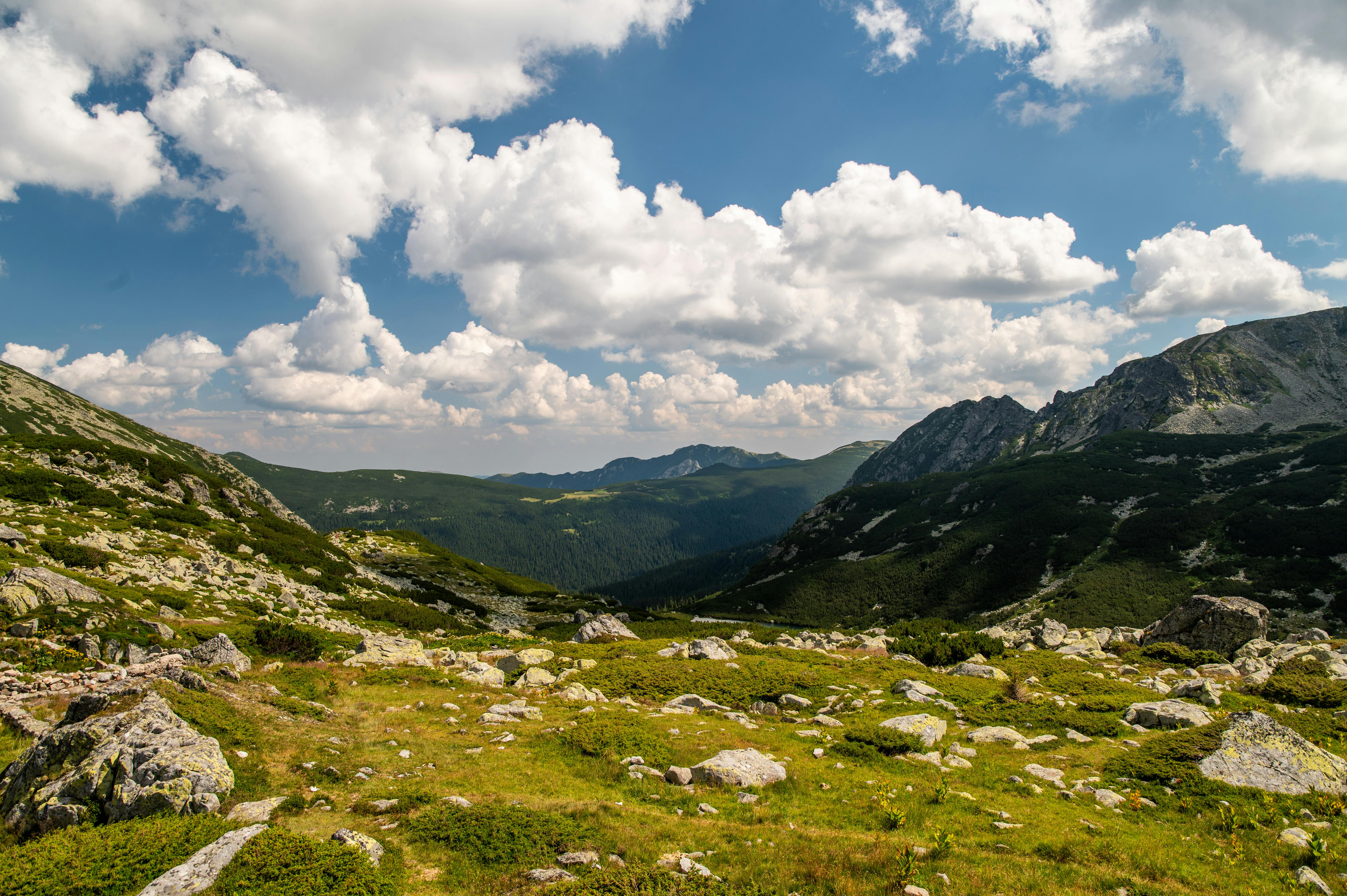 Stunning view of green alpine meadows under dramatic clouds.