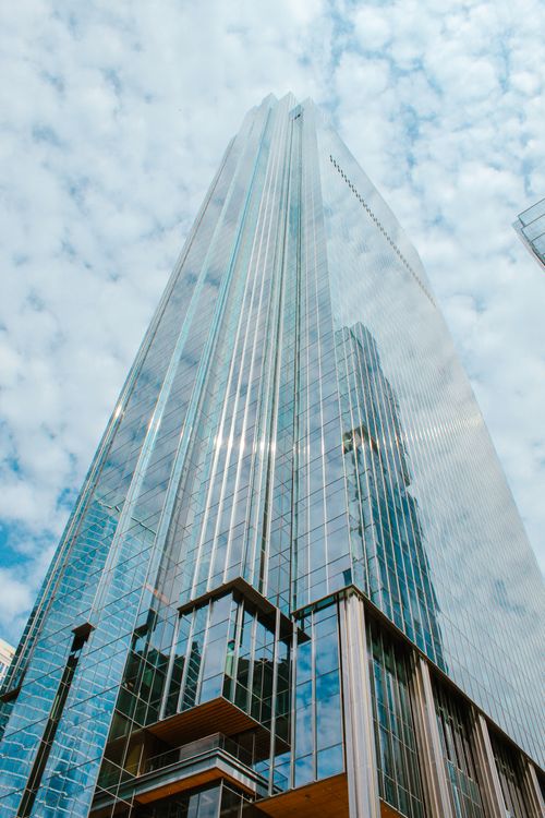 Free Tall glass skyscraper reflecting the sky and clouds, symbolizing modern architecture. Stock Photo