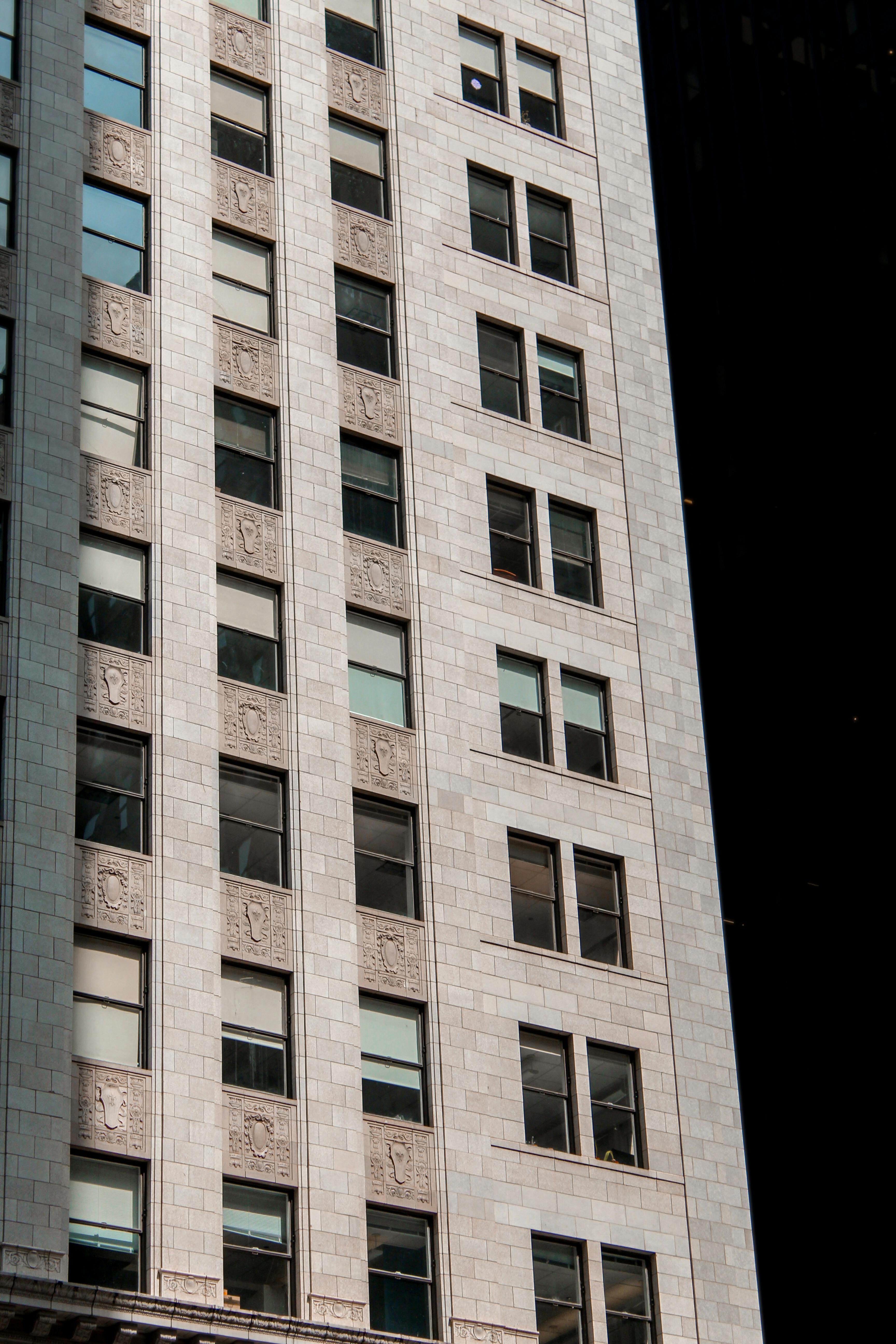 Midtown High-Rise Building Facade in Sunlight · Free Stock Photo