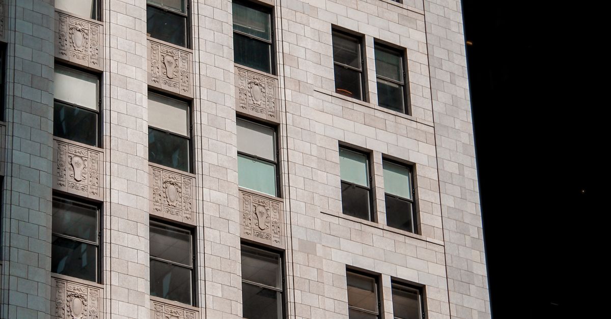 Midtown High-Rise Building Facade in Sunlight · Free Stock Photo