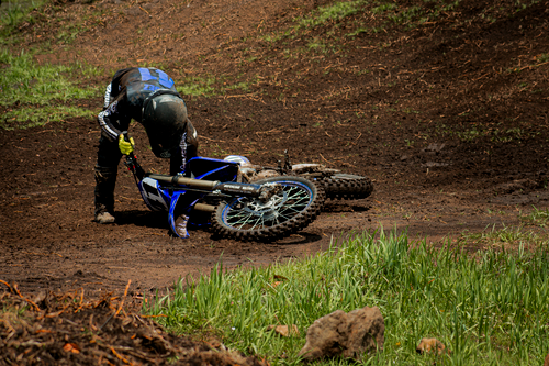 Free A motocross rider recovers after a fall on a muddy track in Mexico City, showcasing resilience in sports. Stock Photo