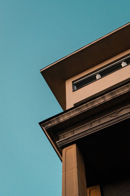 Free Low angle view of modern building facade with clear sky. Minimalist architecture concept. Stock Photo