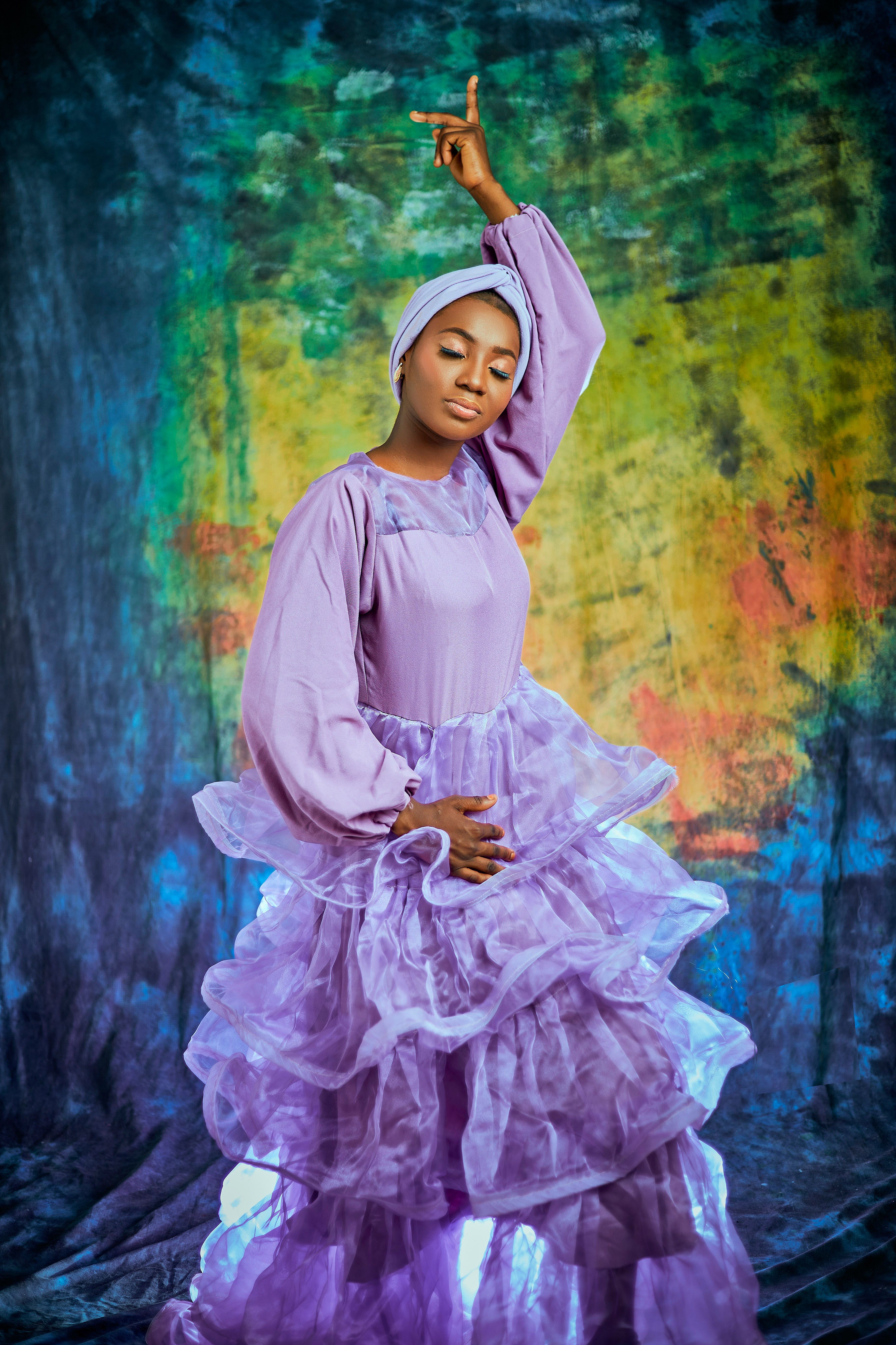 Elegant Portrait of Woman in Flowing Purple Dress · Free Stock Photo