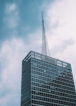 这座现代高层摩天大楼配有玻璃面板和天线，能够抵御变幻莫测的阴云天气