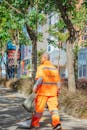 Urban Sanitation Worker in Orange Uniform
