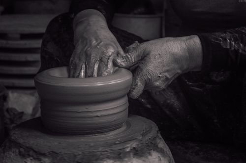 Free Hands shaping pottery in Bac Ninh, Vietnam. Black and white fine art photography. Stock Photo