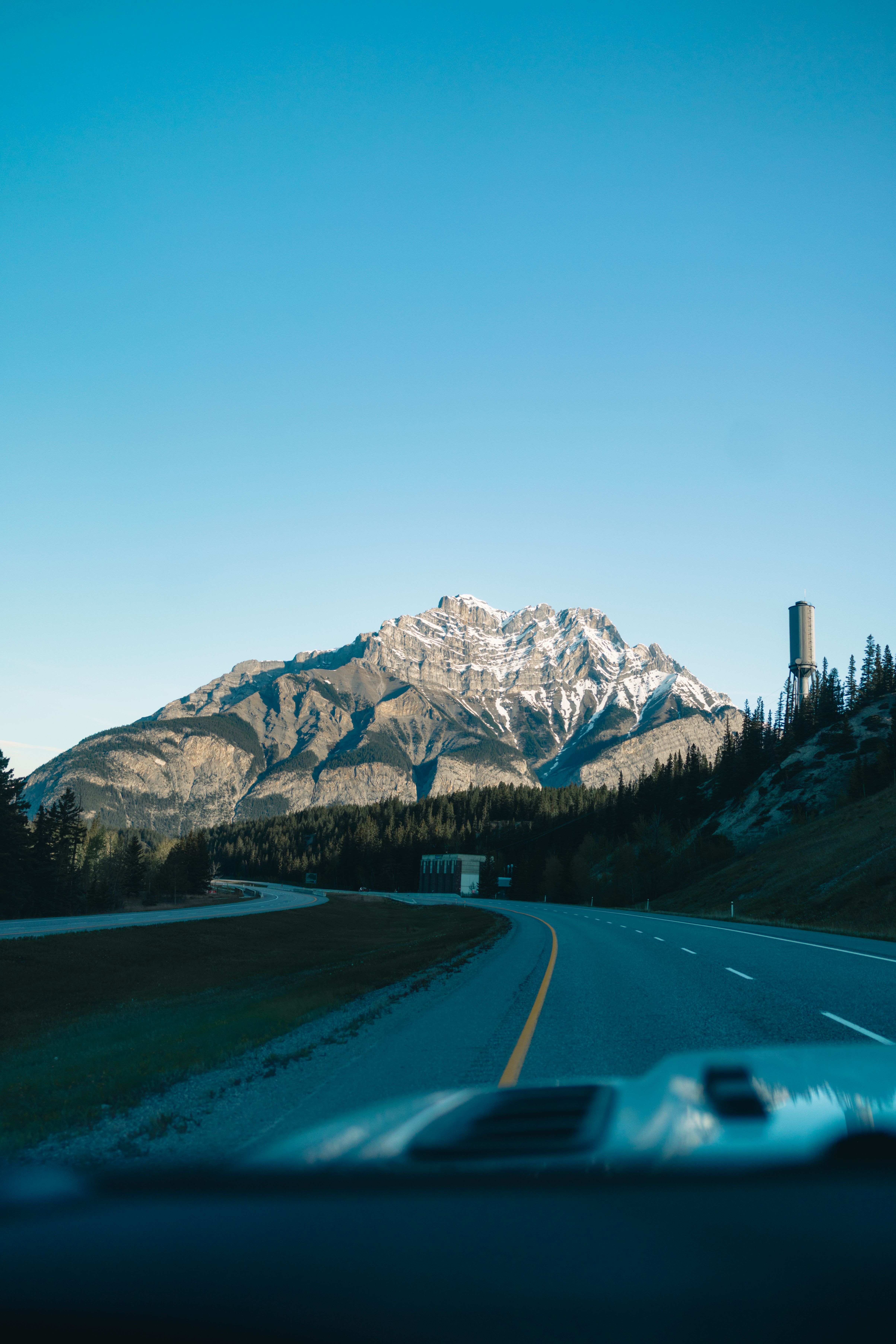 A breathtaking view of snow-capped mountains from a road in Banff, Alberta, Canada.