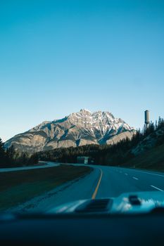 A breathtaking view of snow-capped mountains from a road in Banff, Alberta, Canada.