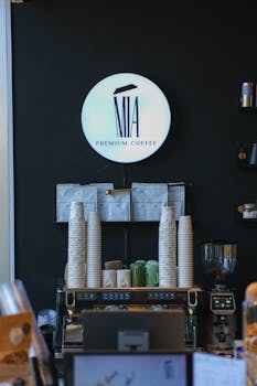 Stylish coffee shop counter with espresso machine and premium coffee branding.
