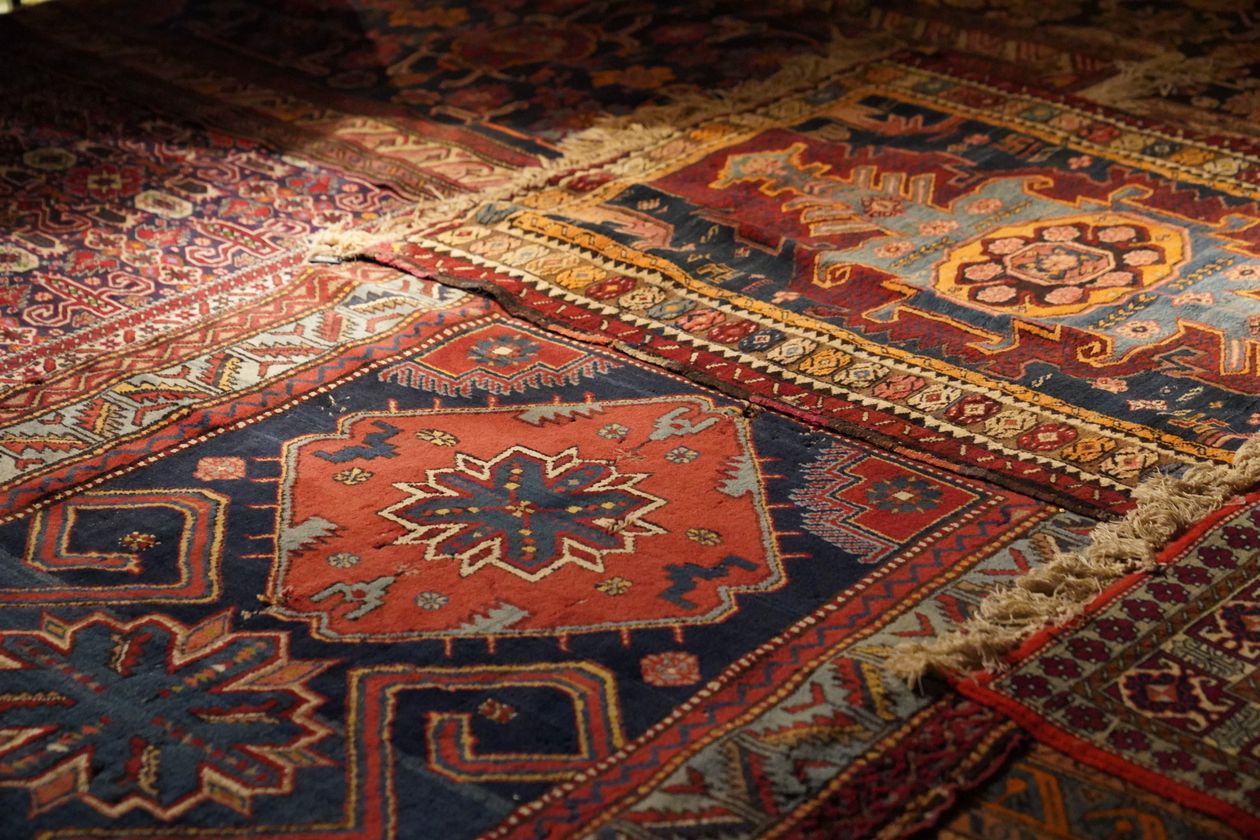 Layered patterned rugs in warm tones