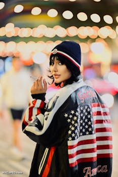 Stylish adult wearing American flag jacket outdoors at night.