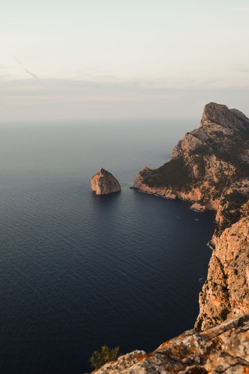 Free Dramatic cliffs overlooking the sea in the Balearic Islands, Spain at sunset. Stock Photo
