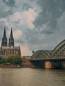 Stunning view of Cologne Cathedral and Hohenzollern Bridge over the Rhine River in Germany.