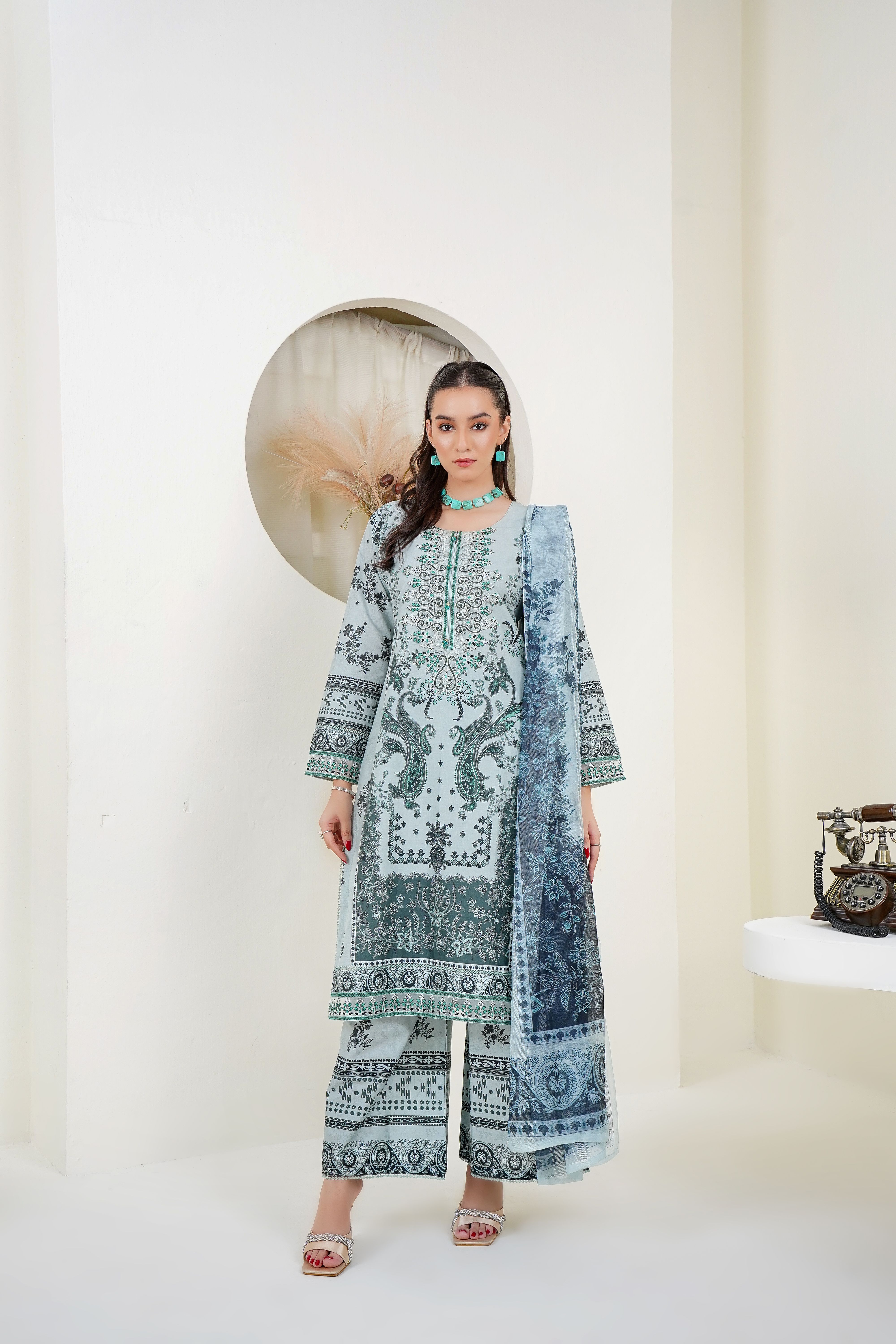 Pakistani fashion model wearing a coordinated printed embroidered suit