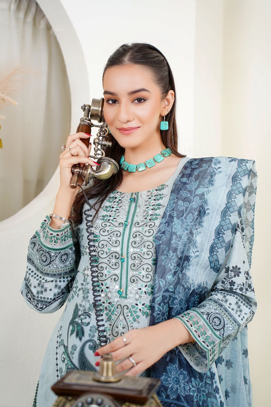 Elegant South Asian fashion model in blue traditional outfit wearing statement earrings