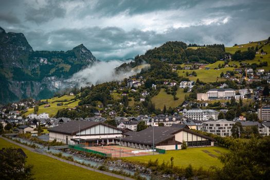 Breathtaking village landscape with mountains and lush greenery in Switzerland.