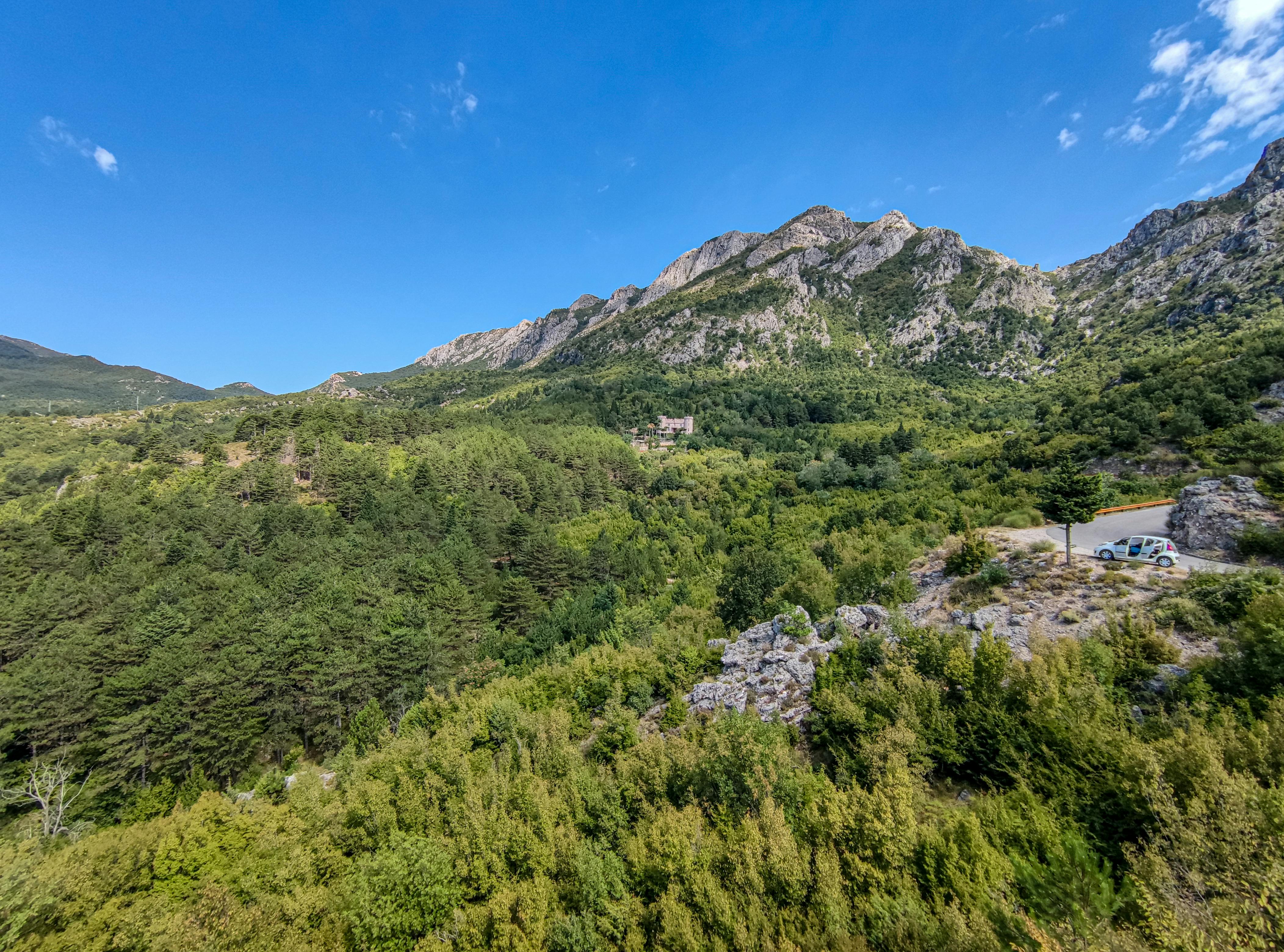 A breathtaking view of lush green mountains in Bar, Montenegro under a clear blue sky.
