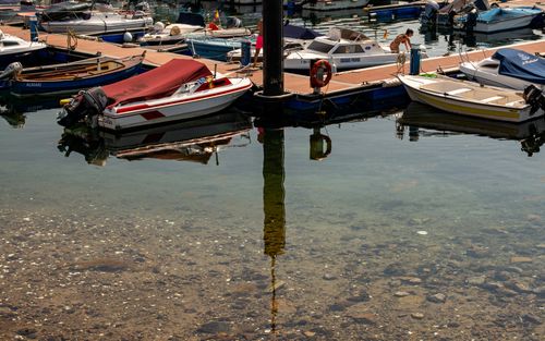 Free Serene view of boats docked in Vigo harbor with clear water reflections. Stock Photo