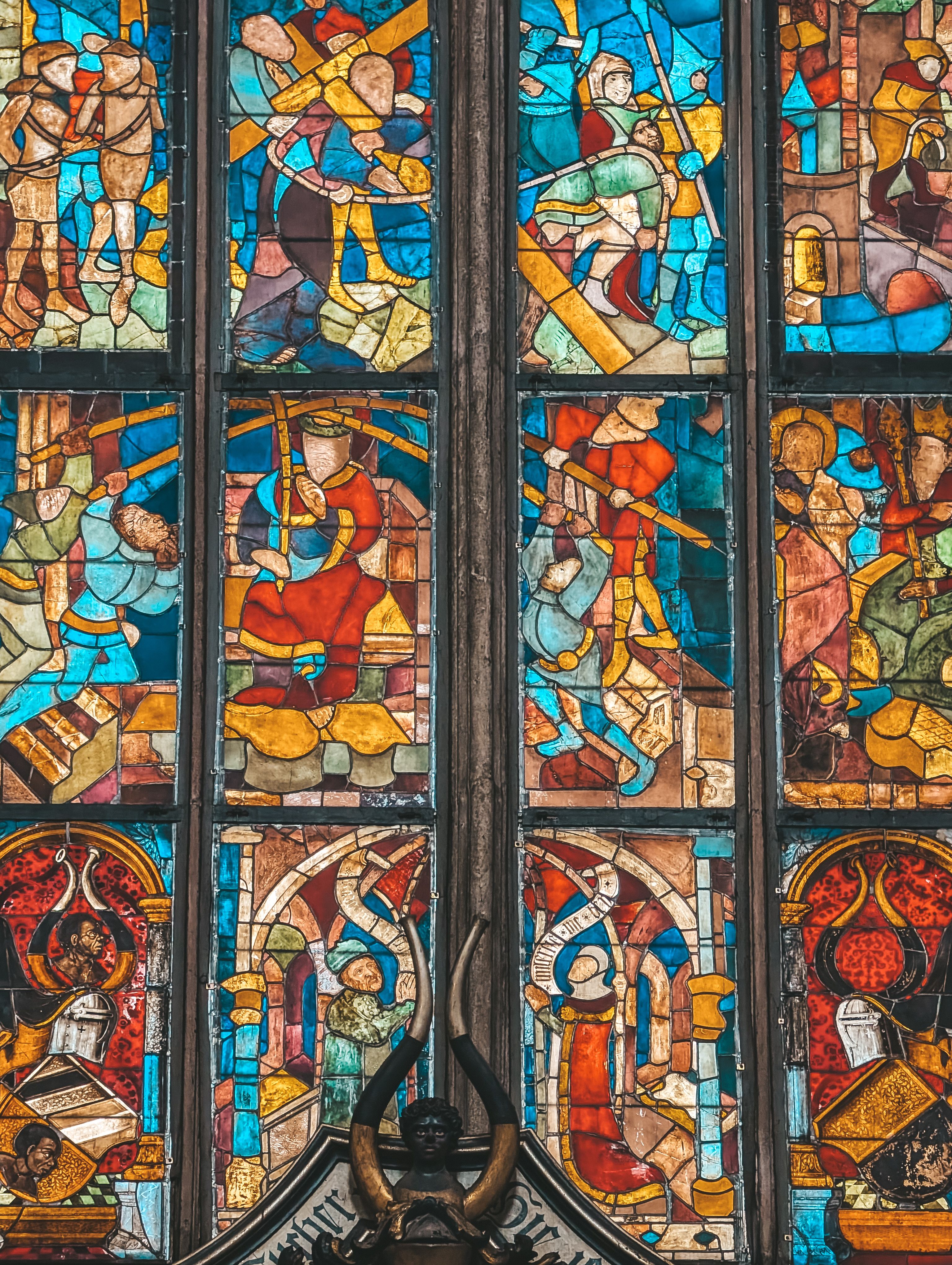 Vibrant stained glass window depicting historical scenes in Nuremberg, Germany.