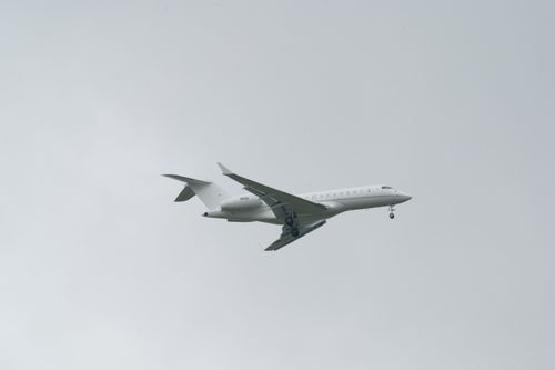 Free A commercial jetliner flying against a cloudy sky, captured in Poprad, Slovakia. Stock Photo