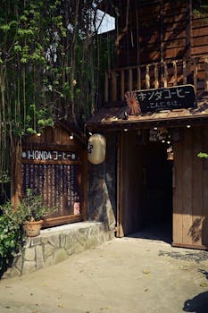 Rustic Japanese café entrance adorned with signage and hanging plants, inviting atmosphere.