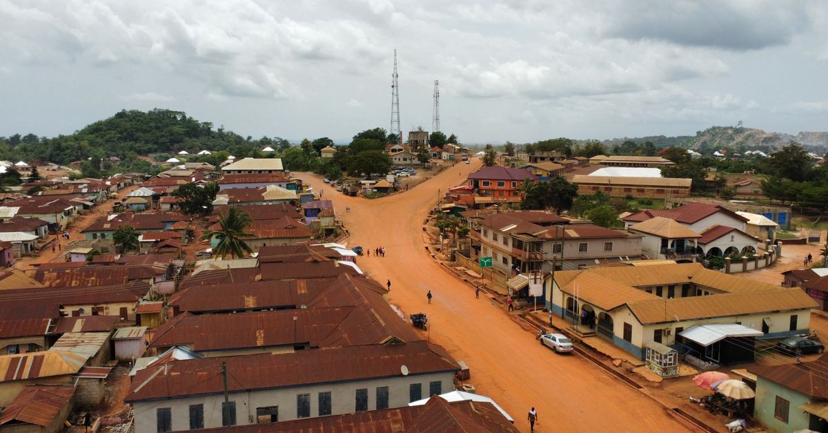 Aerial view of Christ Embassy church building in Ho, Ghana, with surrounding green hills and clear sky