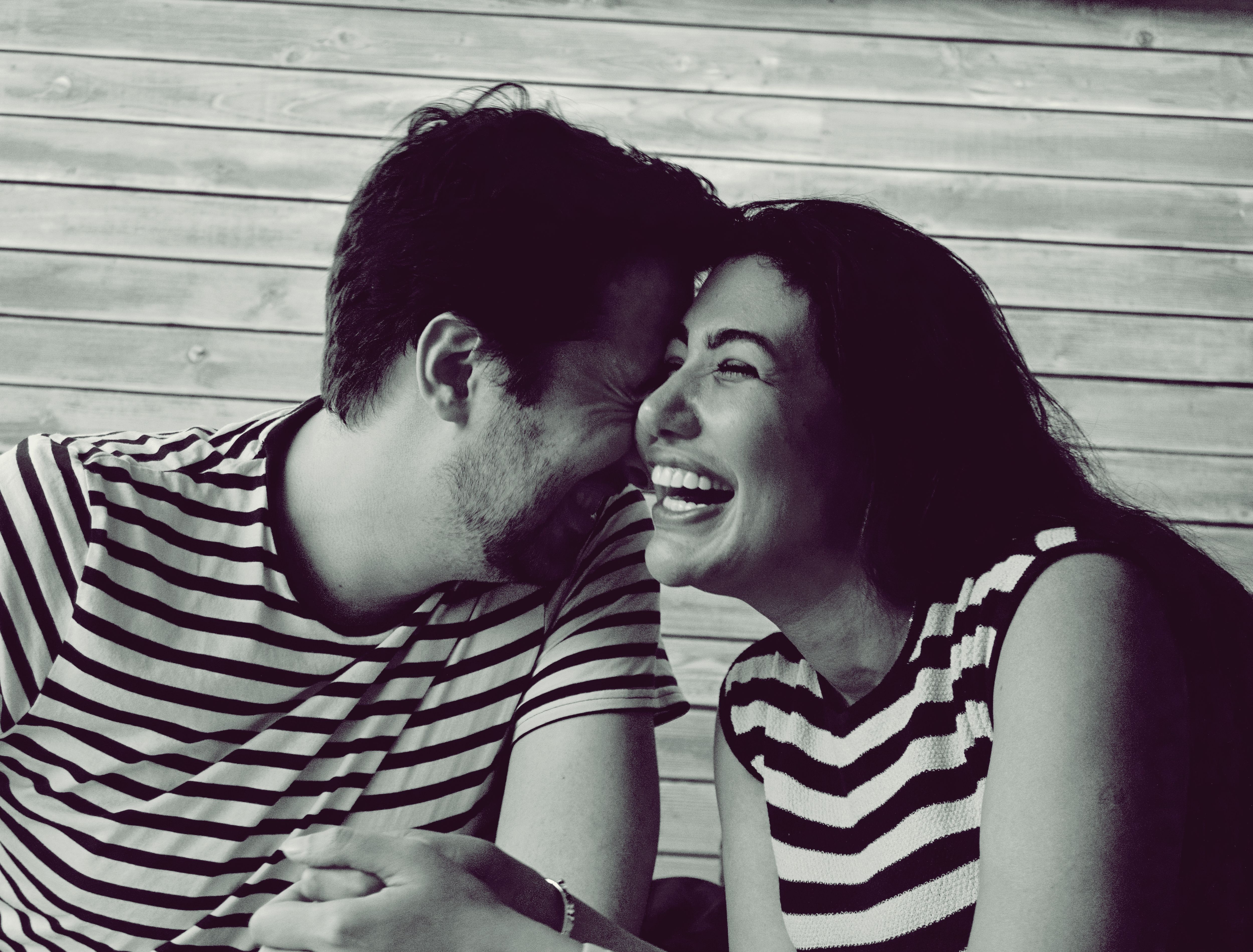Two people laughing together on a date, capturing real connection and relationship-building interaction