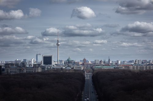 Free A captivating aerial view of Berlin showcasing the iconic TV tower under a dramatic cloudy sky. Stock Photo