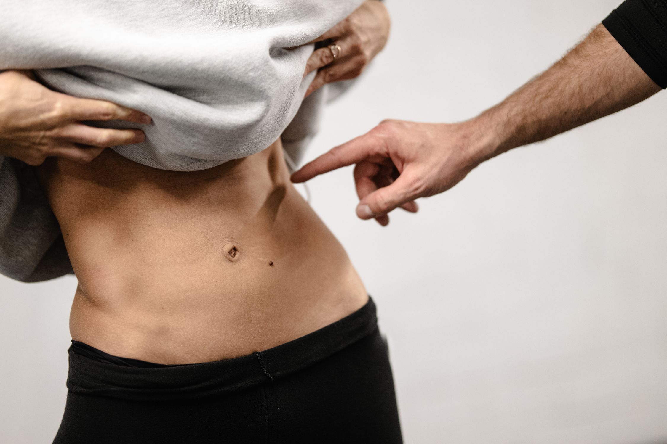 Close-up of a Person's Toned Midsection with Pointer · Free Stock Photo