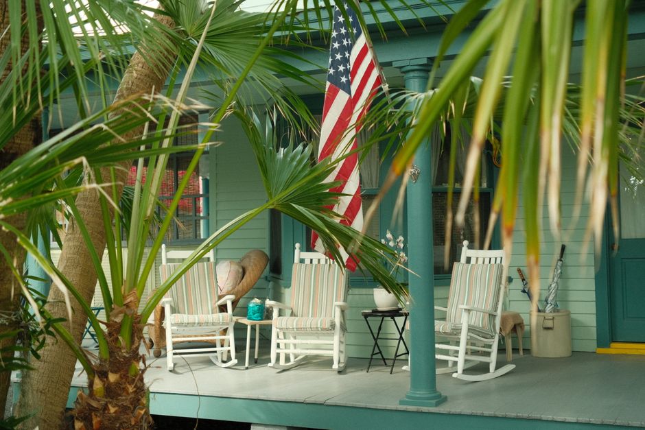 charming southern porch with American flag representing affordable home ownership in low cost of living cities