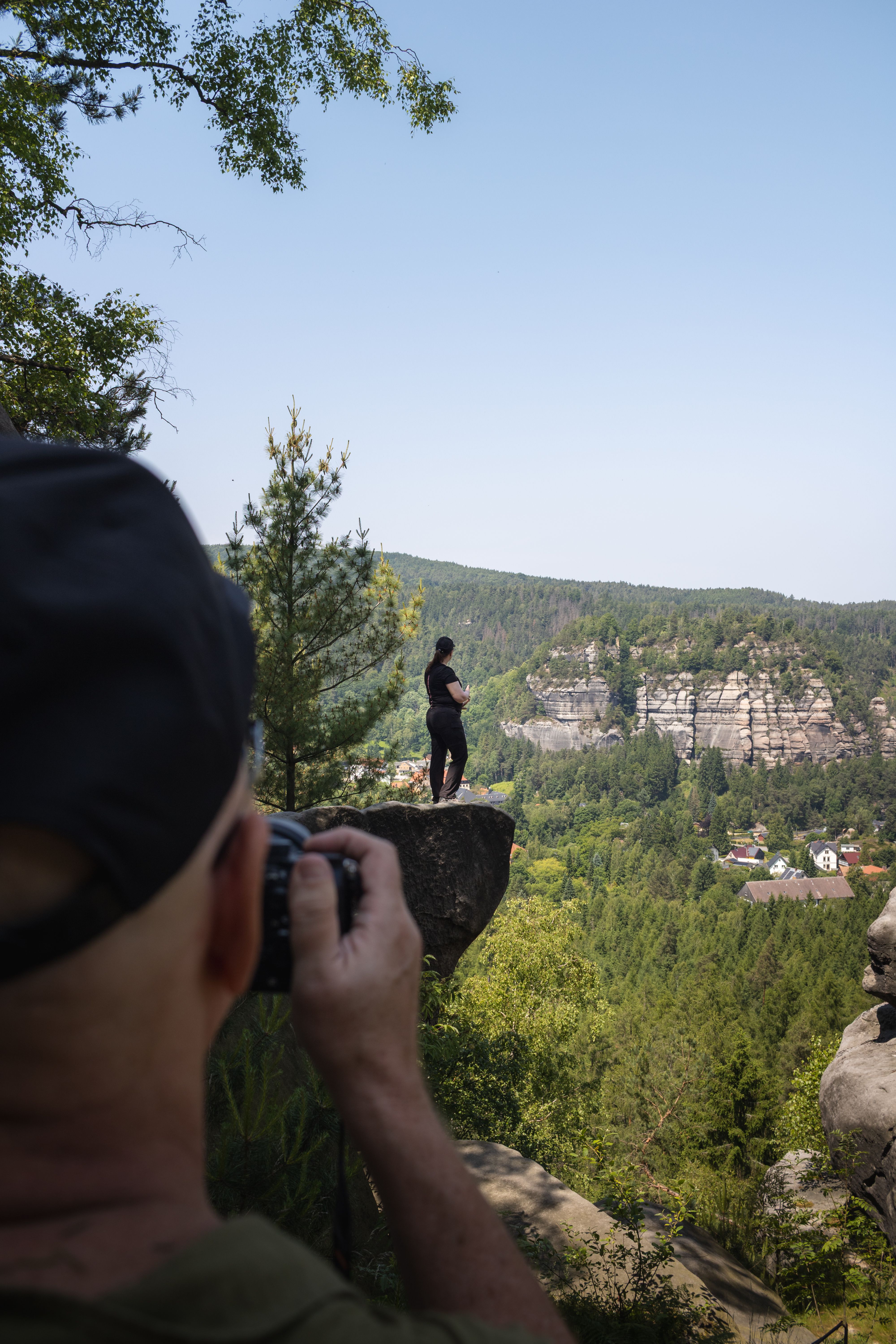 A photographer capturing a breathtaking scenic view in Oybin, Saxony, Germany.