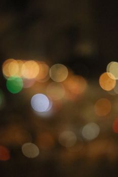 Blurred bokeh lights create a soft, colorful ambiance against a dark backdrop.