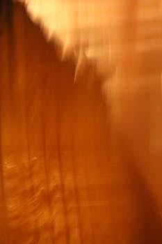 Vibrant abstract blurred orange background with vertical lines.