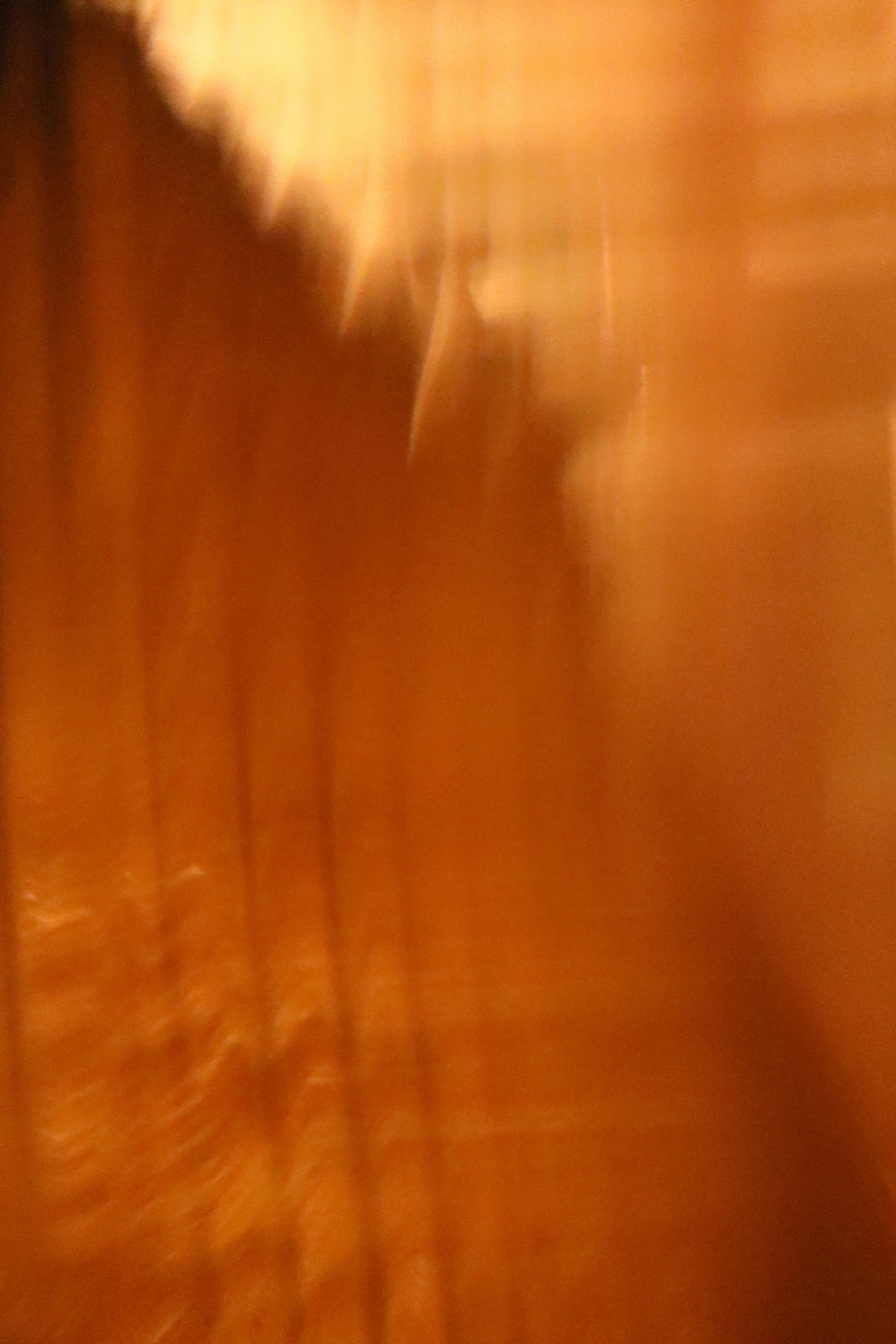 Free Vibrant abstract blurred orange background with vertical lines. Stock Photo