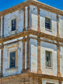 Old architectural building in Cádiz, Spain with a sunlit facade showcasing unique historical design.