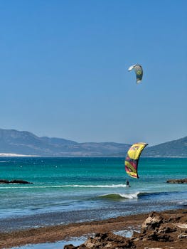 Thrilling kitesurfing scene with vibrant kites over Cádiz beach, Spain.