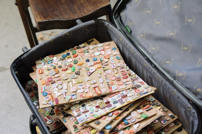 An open case filled with enamel pins — photo by Berna on Pexels