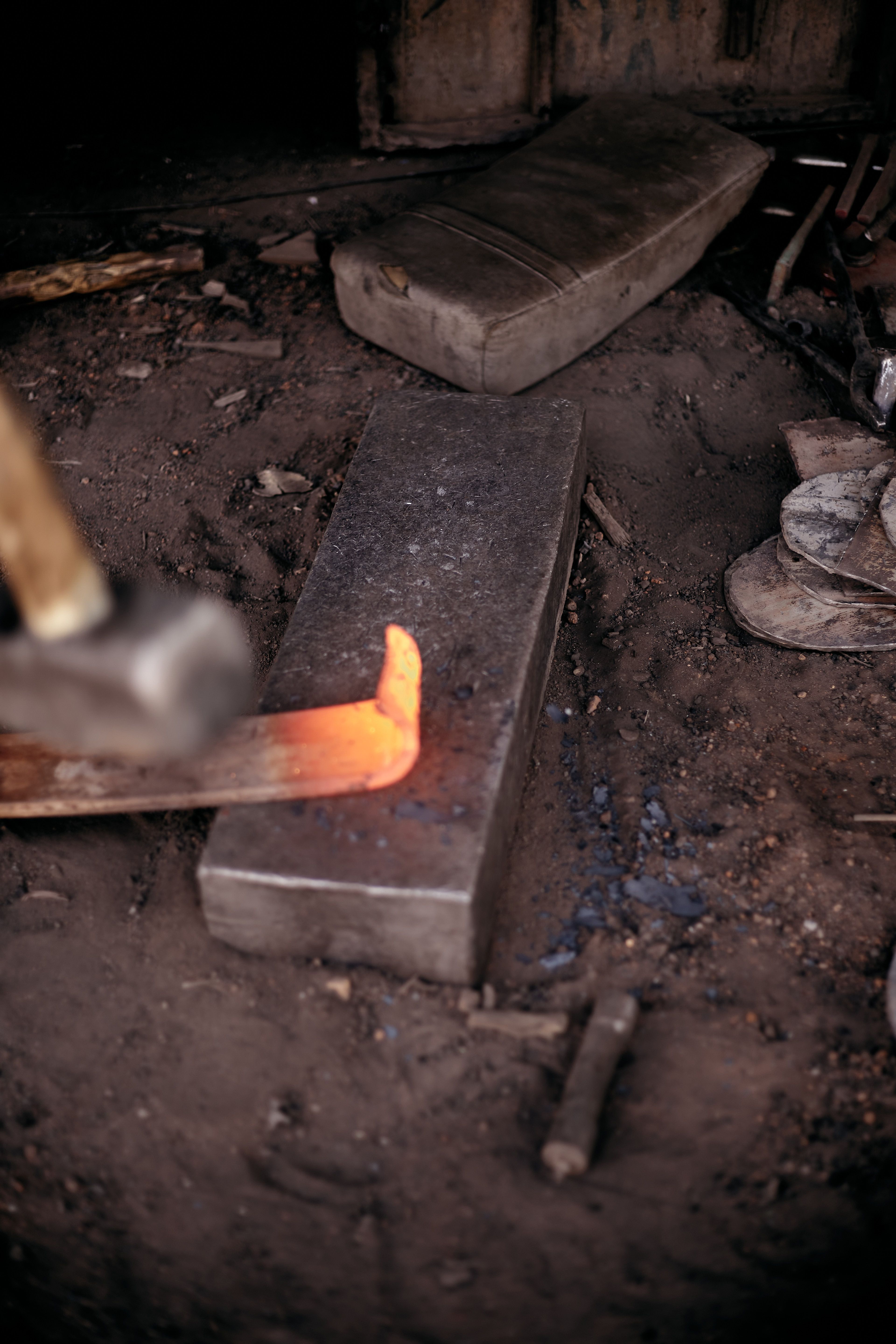 Close-up of heated metal being forged, showcasing traditional blacksmith techniques.