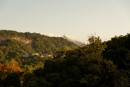 Free A breathtaking view of Rio de Janeiro's lush hills featuring the distant Christ the Redeemer statue. Stock Photo