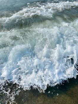 Captivating image of ocean waves crashing on the shore, showcasing foamy white water.