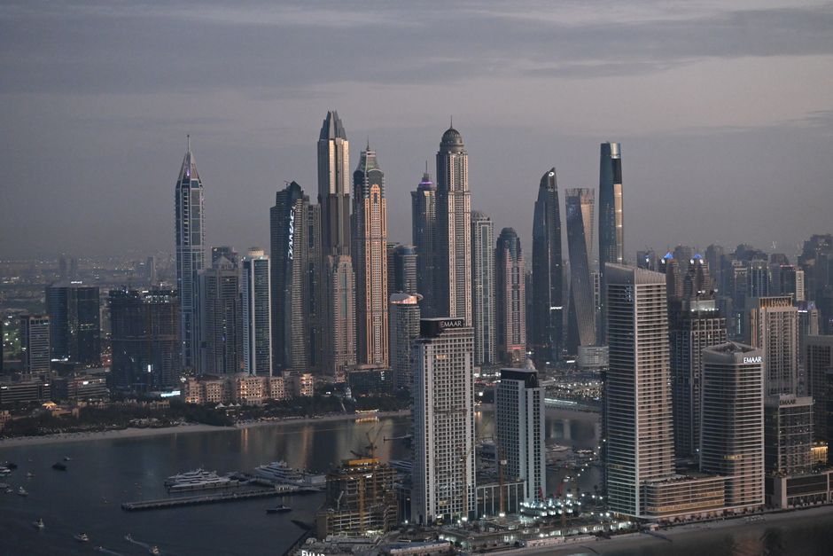 Stunning 12-Minute Helicopter Tour & Desert Safari in Dubai Combo Review Review 2026 - A breathtaking view of Dubai's skyline at twilight with majestic skyscrapers and waterfront.